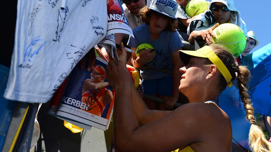 Centre of attention ... Angelique Kerber signs autographs for supporters after beating Lucie Hradecka.