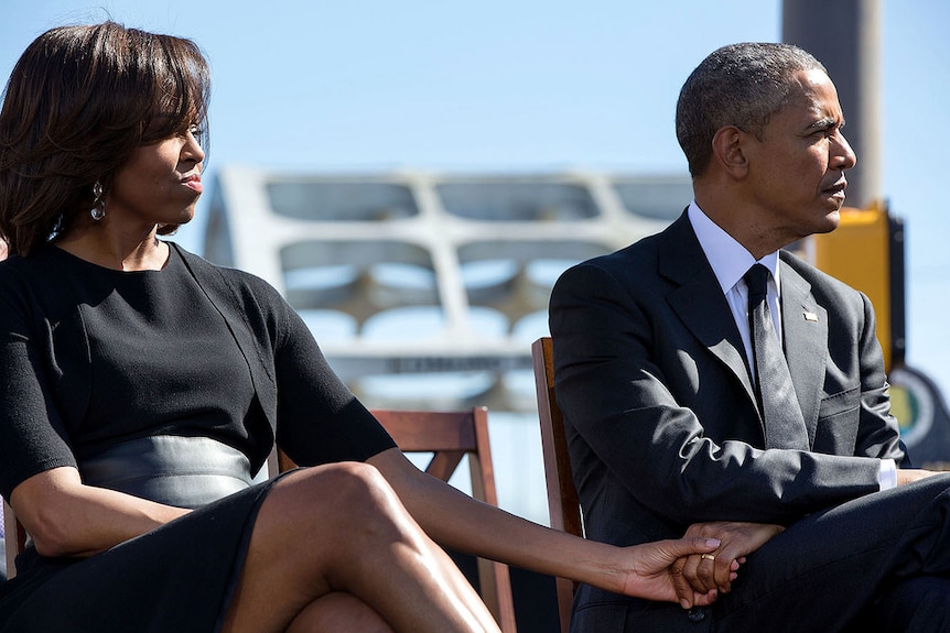 President Barack Obama and the First Lady hold hands