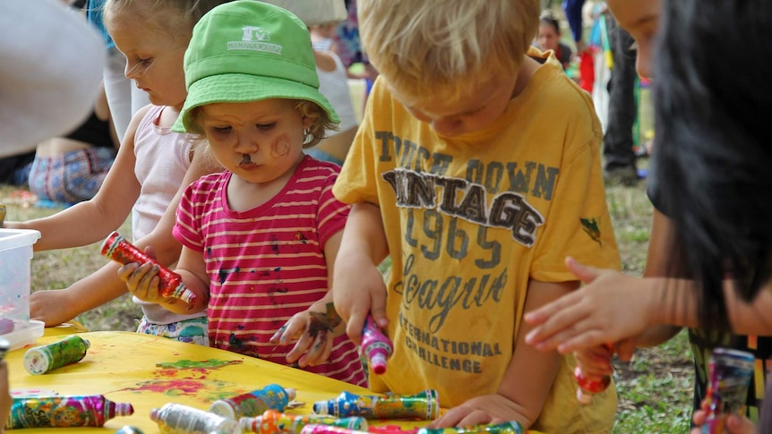 Children with pain on their faces engage in painting
