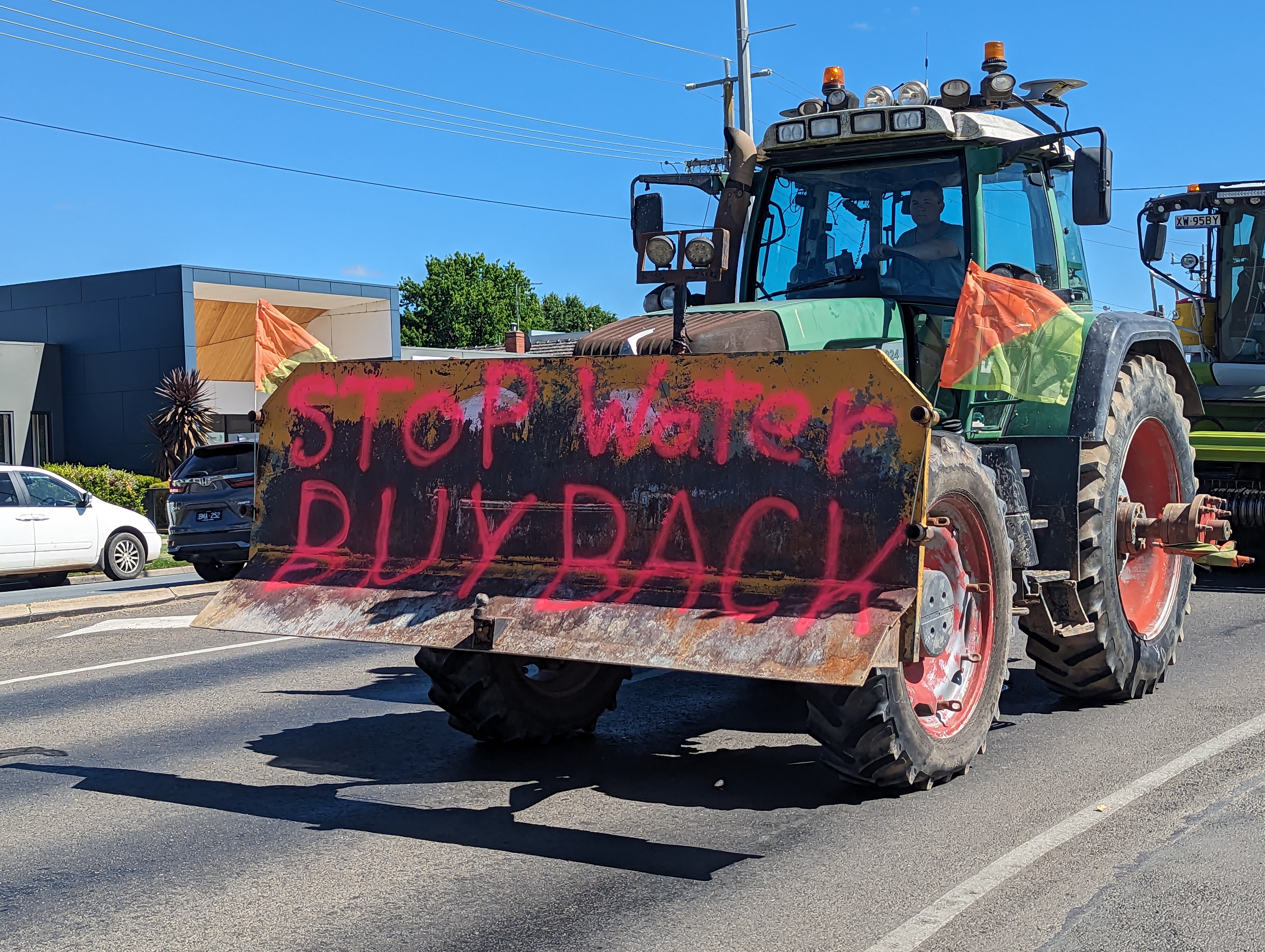 A tractor with "stop water buyback" painted on its front drives down Wyndham Street in Shepparton.