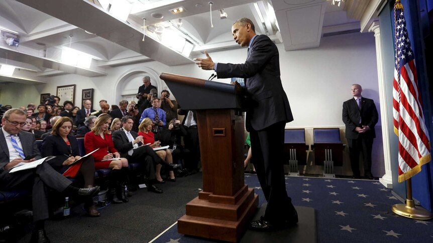 Barack Obama delivers speech to audience of press in the White House press briefing room.