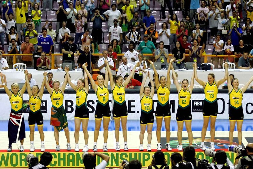 The Australian Opals basketball team stand on the podium raising their hands after winning the FIBA world championships in 2006.