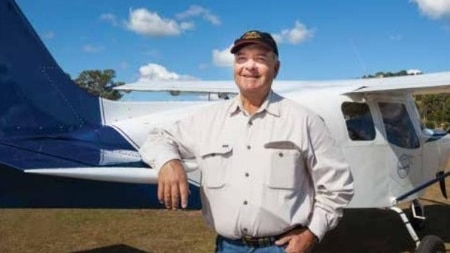 Pilot Peter Gesler stands next to his Brumby 610 aircraft.