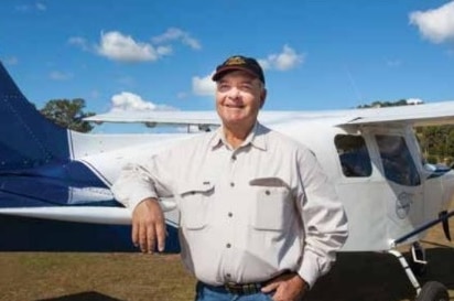 Pilot Peter Gesler stands next to his Brumby 610 aircraft.