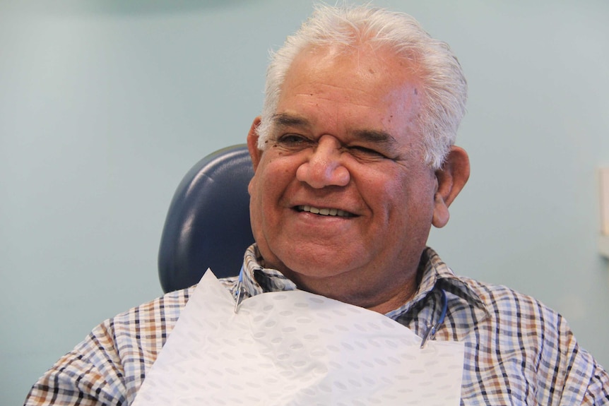 Barry Sampson smiles in a dental chair