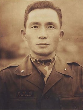 A black and white photo of a Korean man in a military uniform 