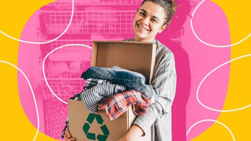 A woman with brown hair is seen smiling as she holds a cardboard box filled with clothes, cut out against pink and yellow.