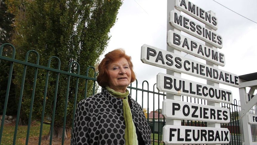 A woman looks up at a collection of railway sidings names outside a museum