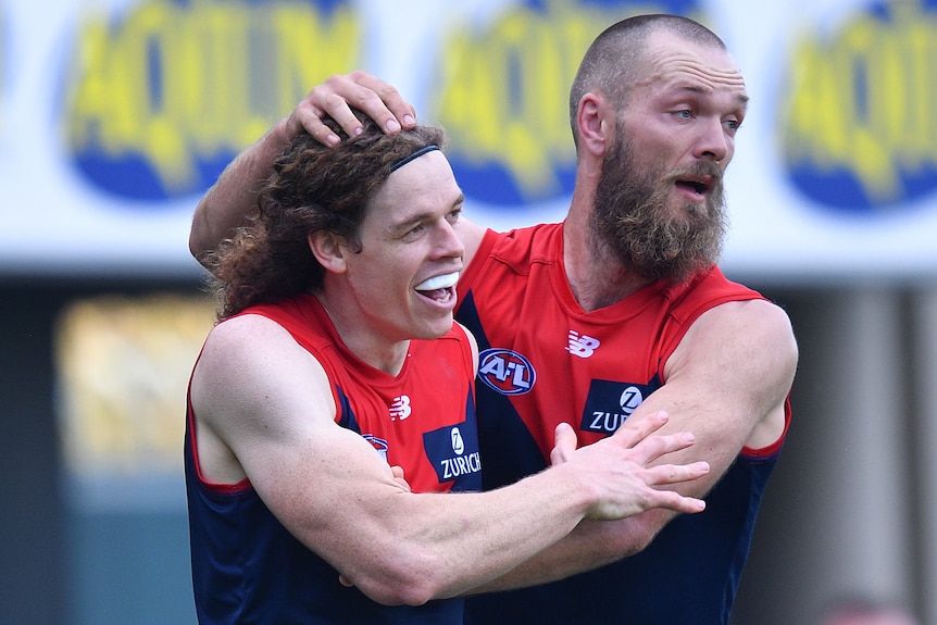 Ben Brown and Max Gawn embrace after a Melbourne Demons goal in the AFL game against North Melbourne.