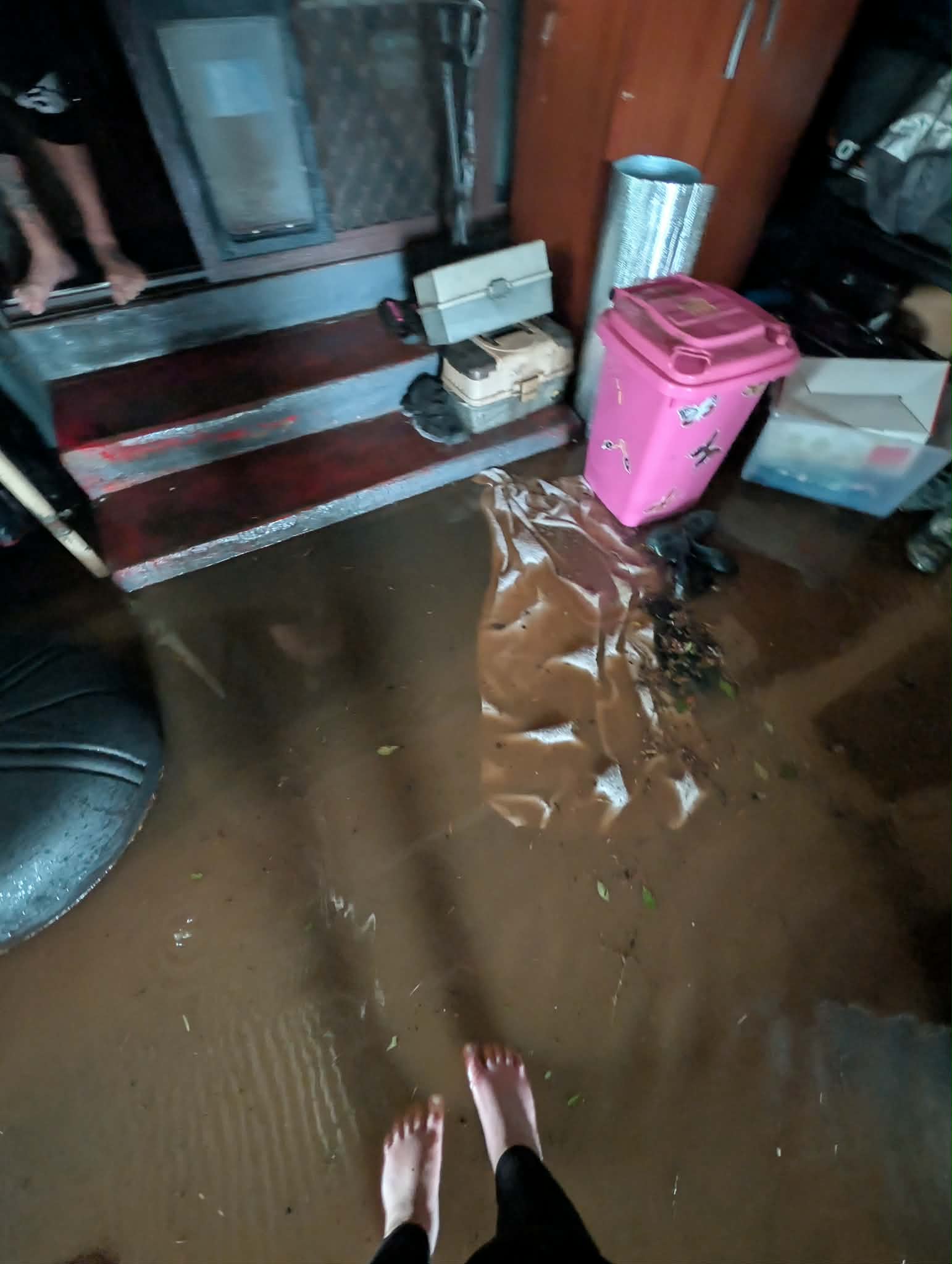 Dirty water covering the ground leading up to steps.