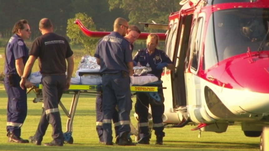 Paramedics treat a two-year-old boy before he is transferred into an ambulance helicopter and flown to hospital.