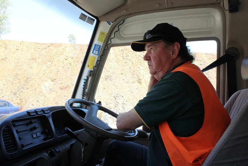 a man behind the wheel of a van