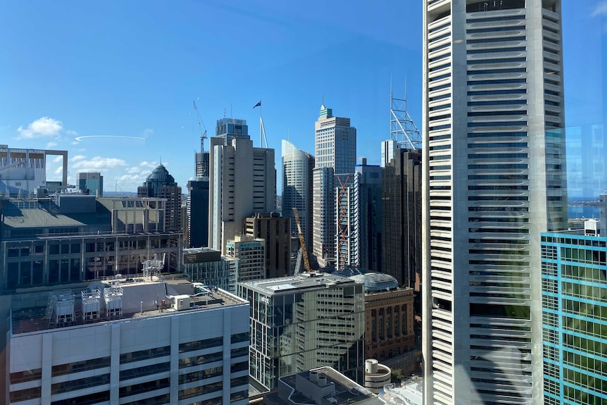 A row of high rise buildings set in front of a blue sky.