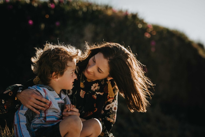 Catherine Sharp and her son cuddle on the beach