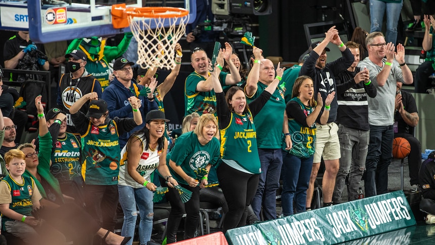 Fans courtside during Tasmania JackJumpers basketball game.