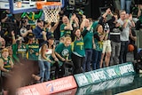 Fans courtside during Tasmania JackJumpers basketball game.