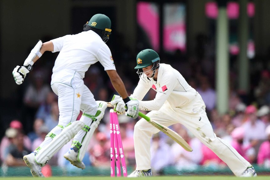 Peter Handscomb whips the bails off to complete a run out