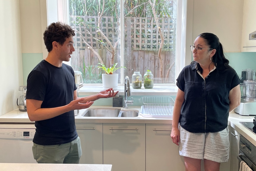 Yannai gestures with his hands as he explains an experiment's results to Brigid.