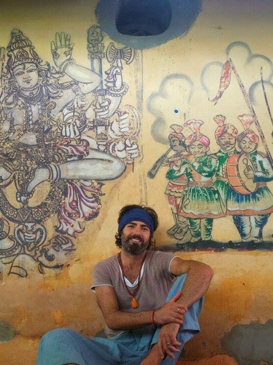 Jorge Invernon sits against a wall in India.