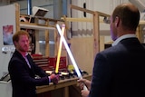 Harry and William stage a lightsaber battle.