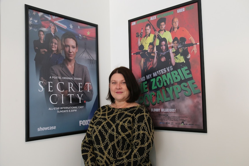 Monica Penders with posters for two Canberra productions.