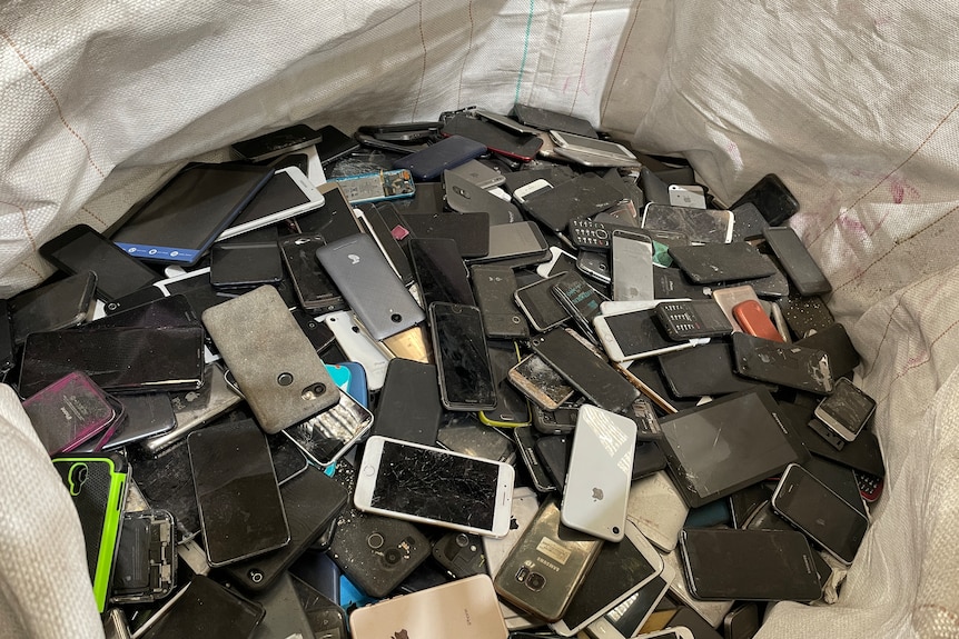 hundreds of cracked old iphones in a bag