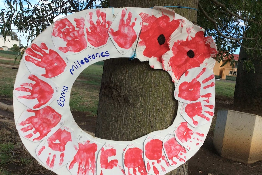 A handmade wreath featuring kids handprints on Bottle Tree on Roma's Heroes Avenue