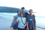 hani, her husband and their kids standing in the beach