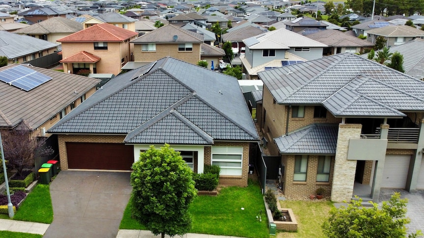 Aerial view of rows of new houses in outer suburbia.