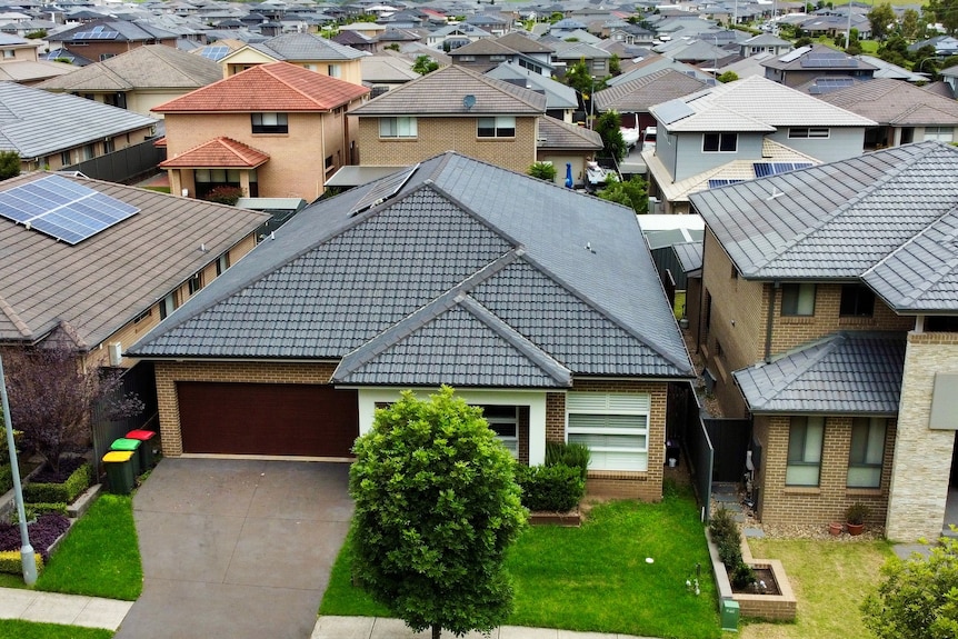 Aerial view of rows of new houses in outer suburbia.