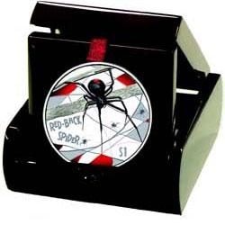 A Red Back spider commemorative coin in it's case.