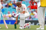 Joe Root kneeling with a water bottle as he takes a break during the final day of the fifth Ashes Test at the SCG.