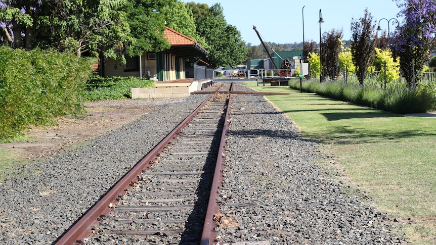 An old railway line running off into the distance in a country town