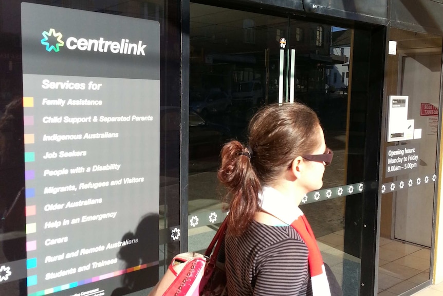 A woman walks past the Centrelink office in Marrickville, Sydney