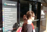 Woman walks past Centrelink office