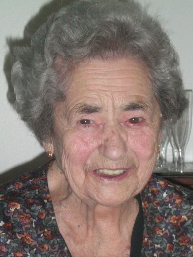 An elderly woman smiling.