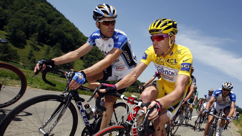 Cadel Evans rides in yellow jersey