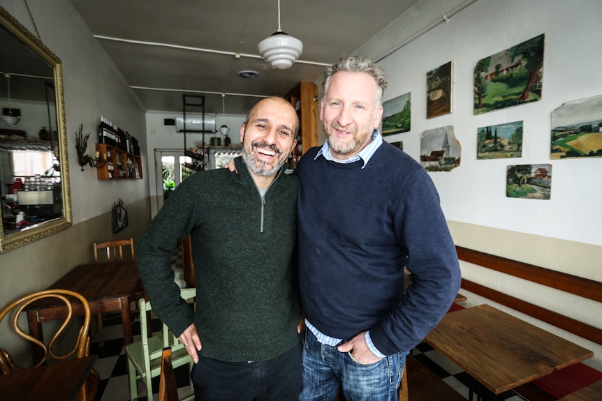 Castlemaine cafe owner, Italian born Luca Sartori sitting in his empty cafe.