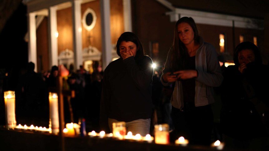 Shocked mourners near scene of shooting