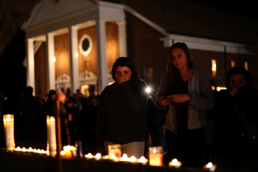 Shocked mourners near scene of shooting