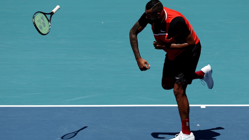 A man hurls a tennis racket across the court