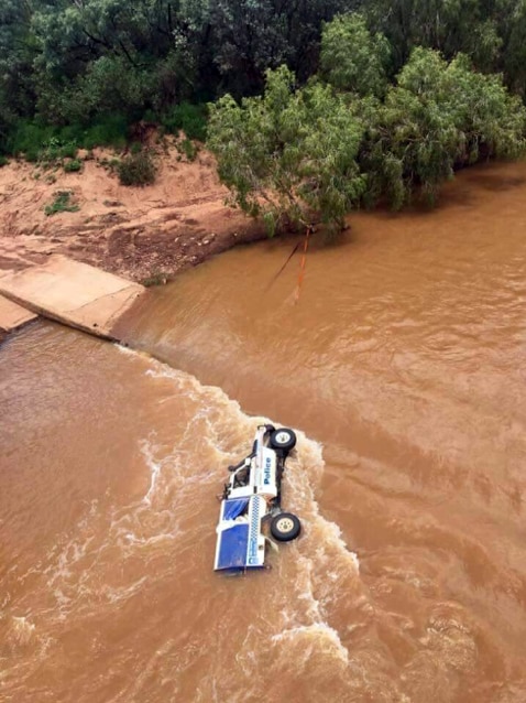 Police were able to get to safety after their van washed off Dashwood Crossing in the Victoria River.
