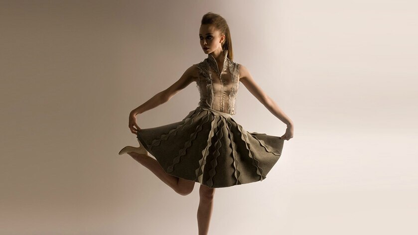 A fashion model poses in a zero waste dress.