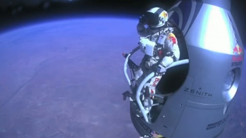 Daredevil Felix Baumgartner salutes before jumping out of a capsule almost 40 kilometres about the Earth's surface.