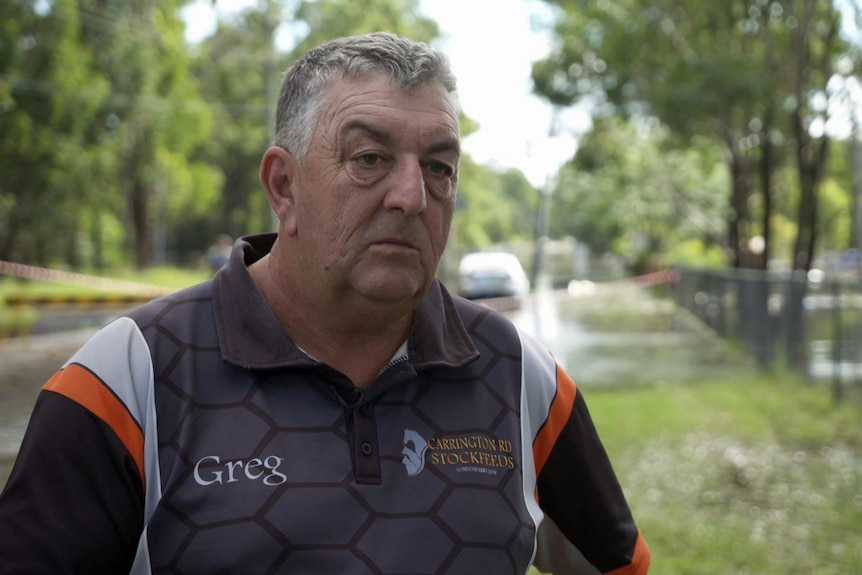 A man standing in front of floodwater