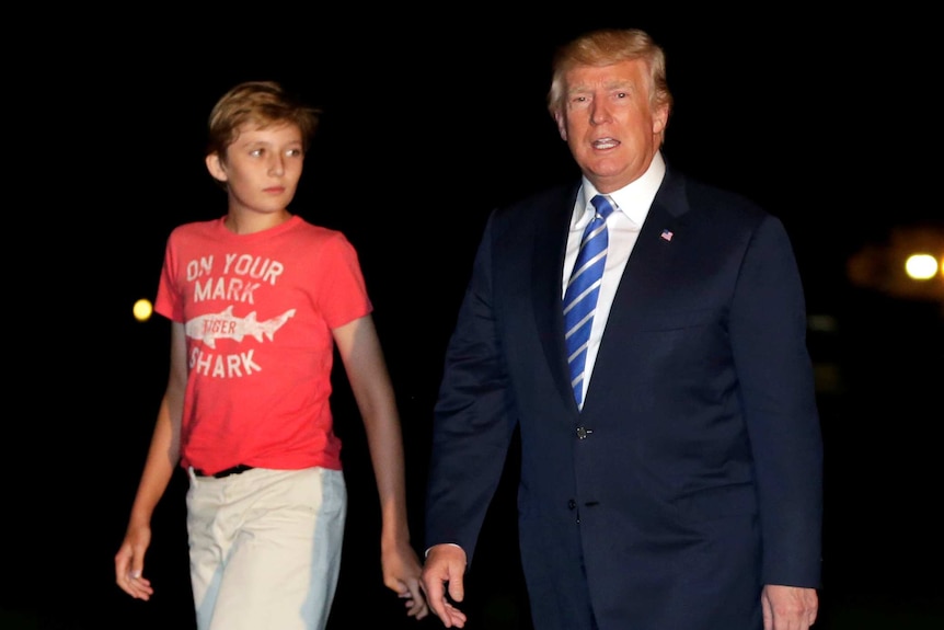 Donald Trump walks with his son Barron.