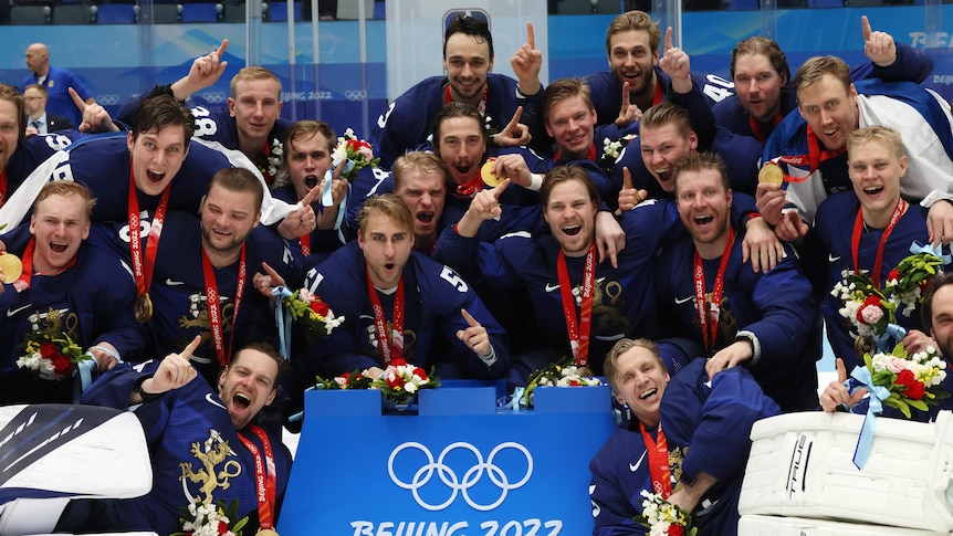 Finland's men's ice hockey team celebrate with their Winter Olympic gold medals.