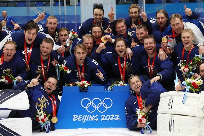 Finland's men's ice hockey team celebrate with their Winter Olympic gold medals.