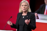 A close up of Magdalena Andersson delivering a speech in parliament.