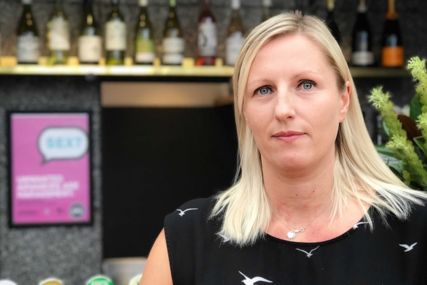 Lara Whalley standing in front of the bar at the Corner Hotel in Melbourne.